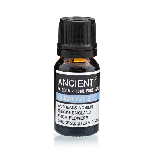 Bottle of chamomile essential oil with a black cap on a white background