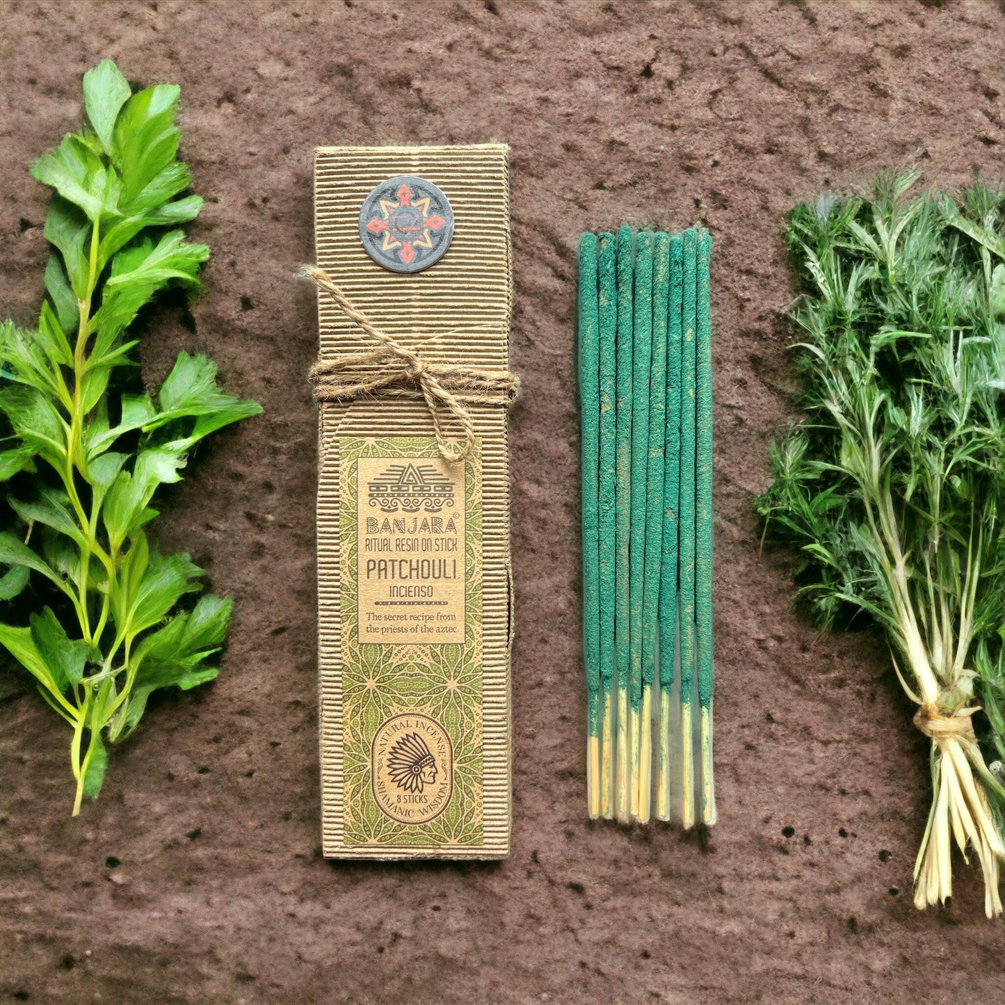 Incense sticks with packaging and herbs on a textured surface