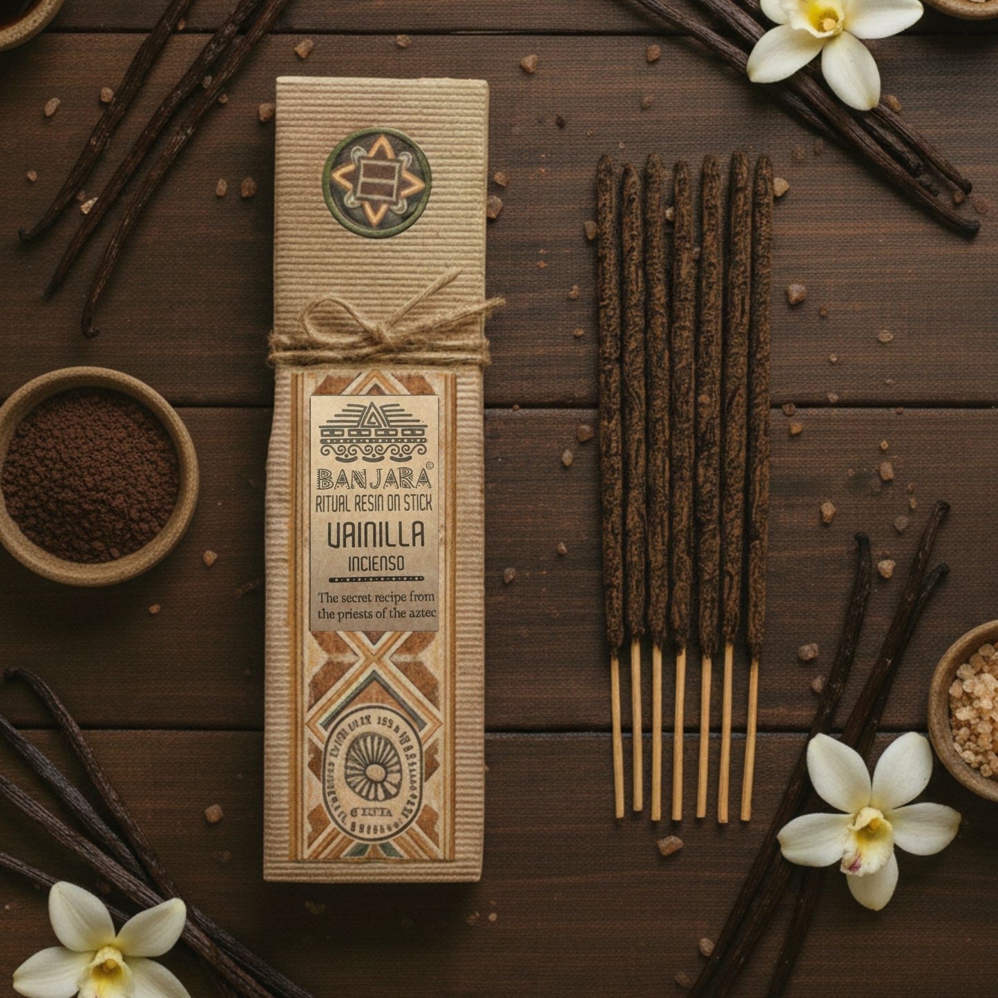 Banjara Vanilla Incense packaging on a wooden surface with vanilla beans and flowers.