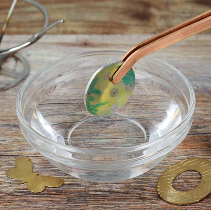 Clear glass bowl with decorative elements on a wooden surface