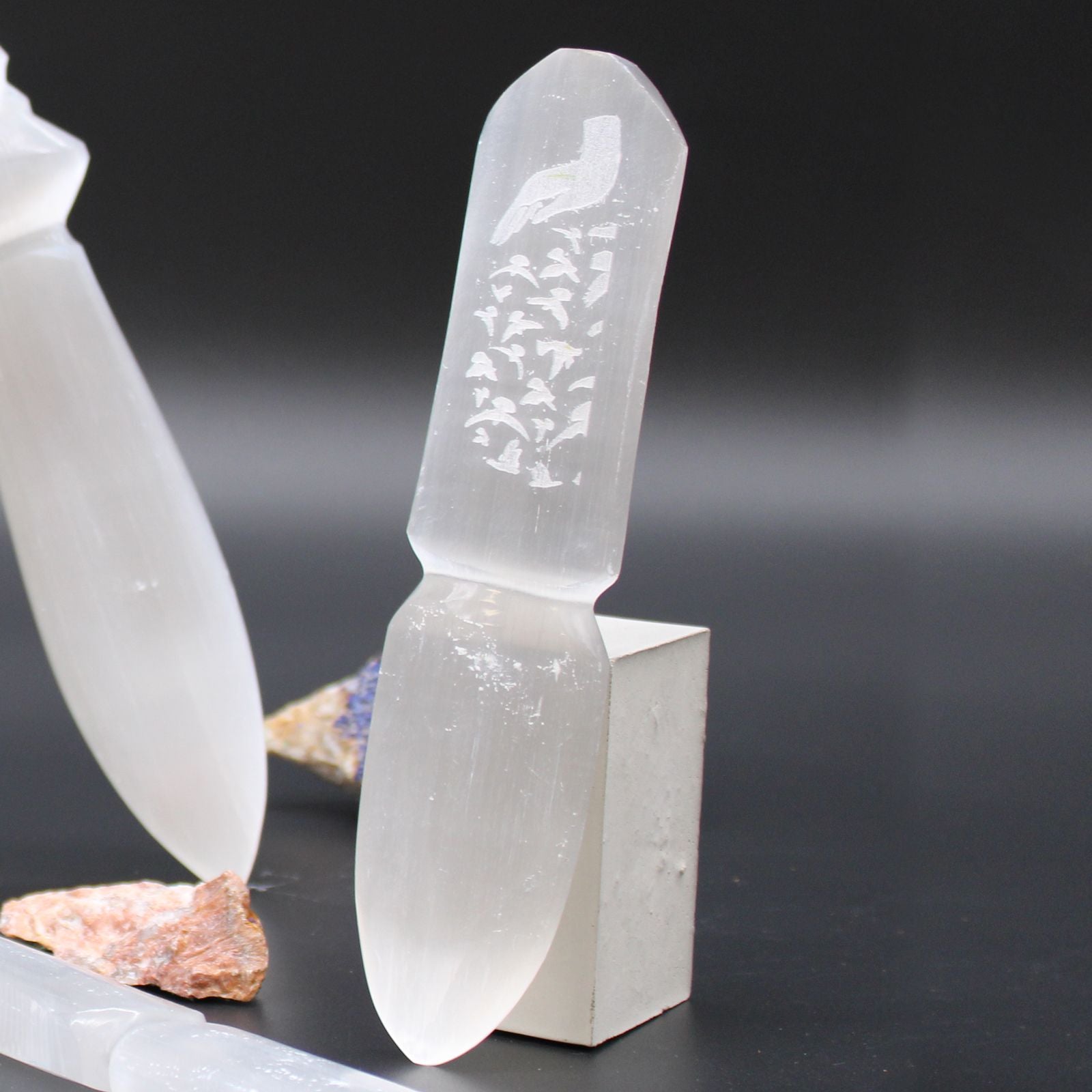 Crystal-like object with engraved design on a dark background