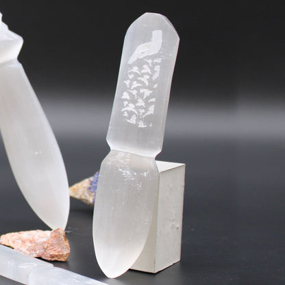 Crystal-like object with engraved design on a dark background