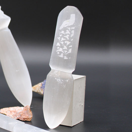 Crystal-like object with engraved design on a dark background