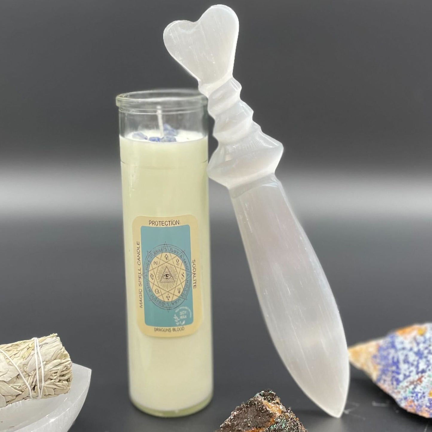 Candle with a heart-shaped wick and crystal on a dark background