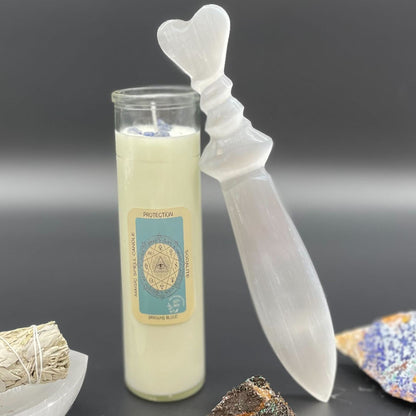 Candle with a heart-shaped wick and crystal on a dark background